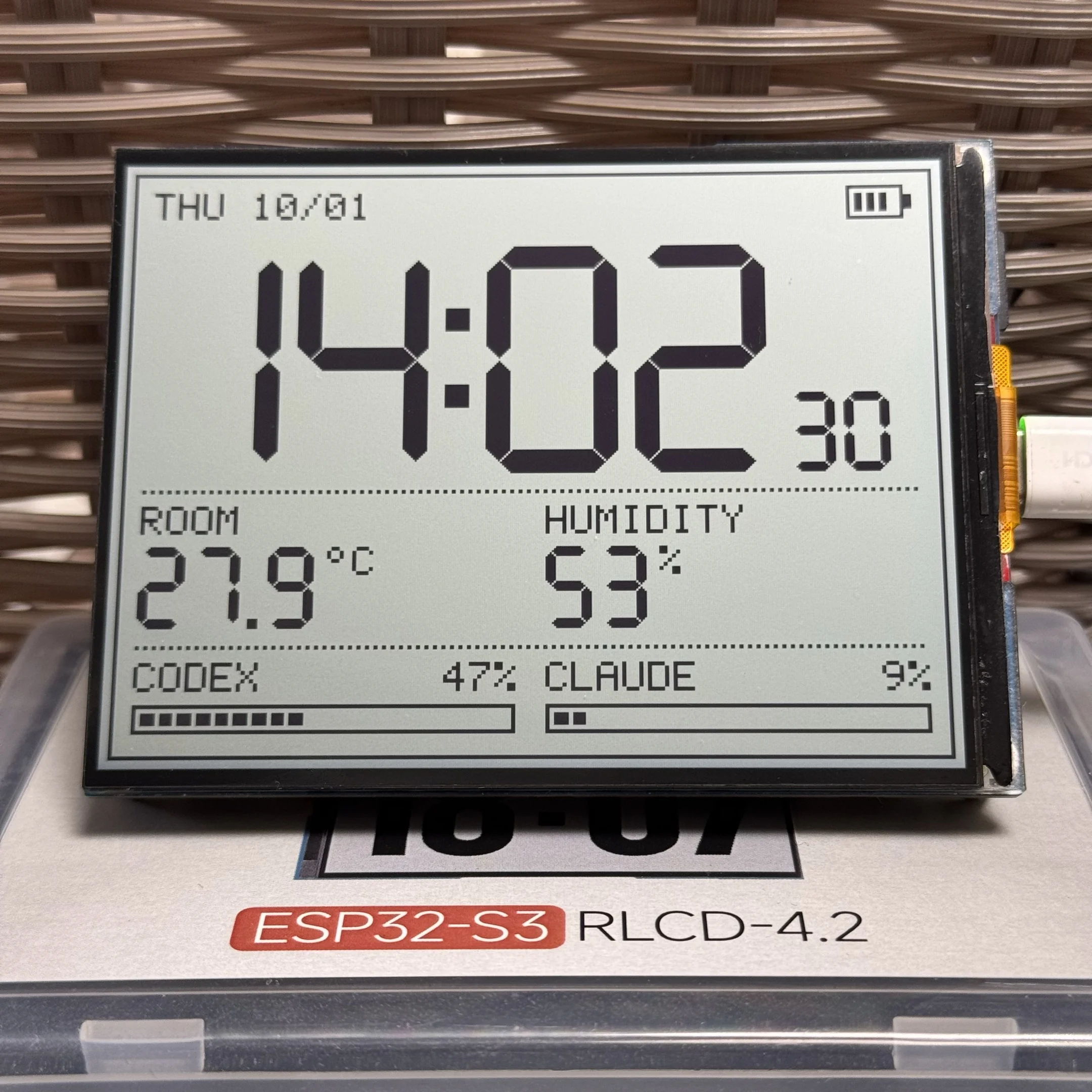 QuotaFrame clock view on the ESP32-S3-RLCD-4.2 showing time, temperature, humidity, and usage percentages